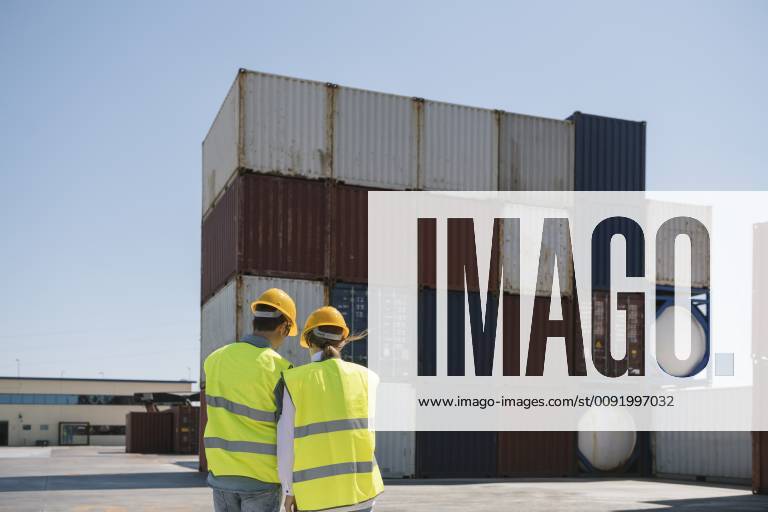Workers in front of cargo containers on industrial site model released Symbolfoto property released AHSF00178