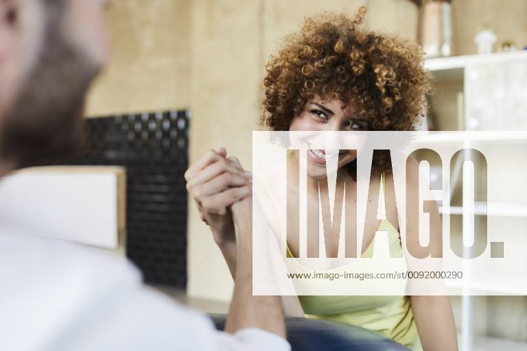 Happy man and woman arm wrestling in office model released Symbolfoto property released FMKF05657