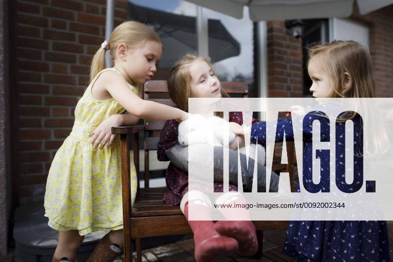 Three girls pettting a bunny model released Symbolfoto property released KMKF00953