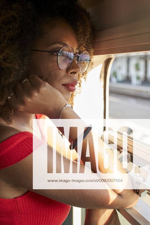 Young woman on a train looking out of window model released Symbolfoto property released VEGF00051