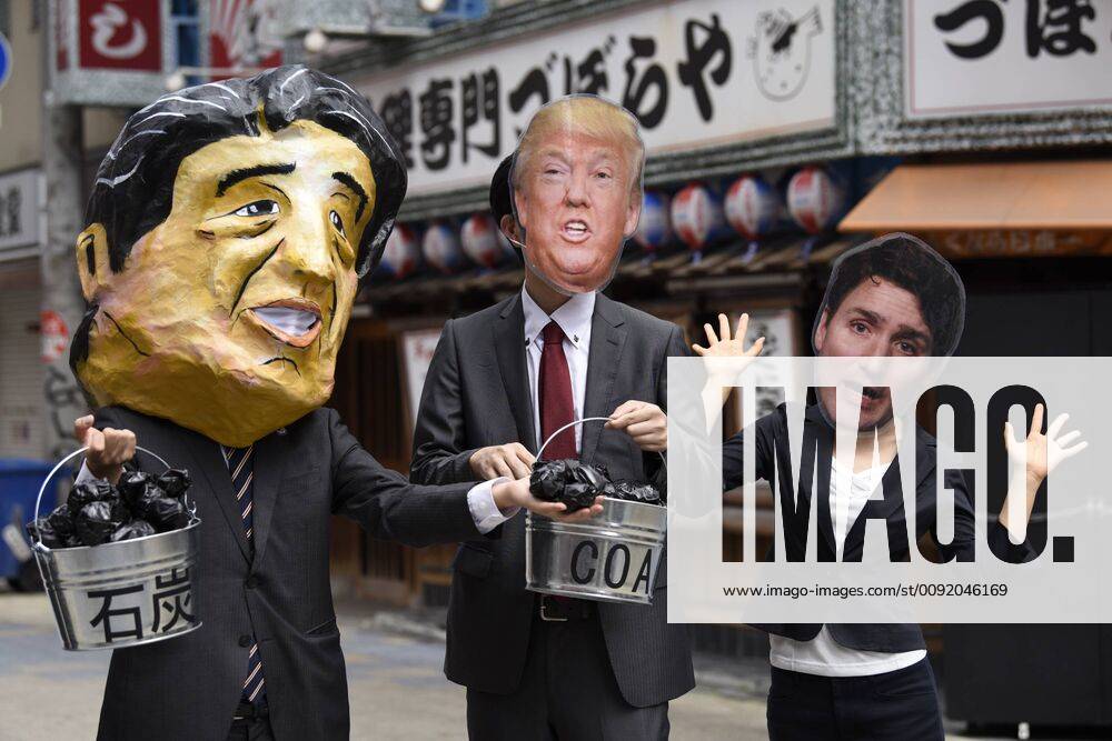 People wearing masks of G20 leaders protest coal power during the G20 Summit in Osaka, Japan. (106854979)