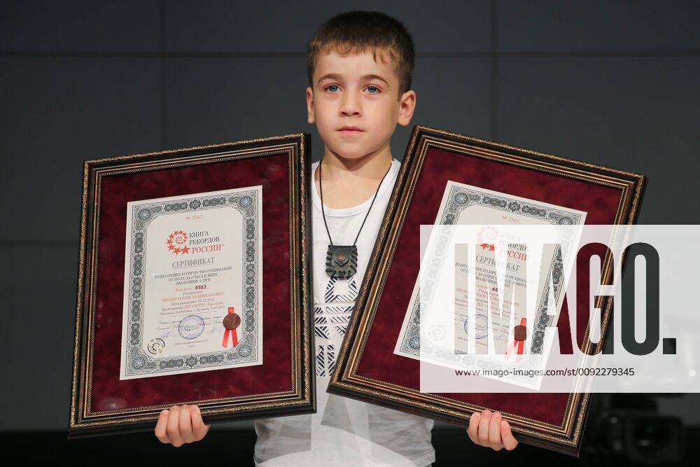 Chechen boy Rokhim Kuriyev, 6, poses for a photograph with two Russian Book of World Records certificates at a studio of the Grozny television and radio broadcasting company in Grozny, Chechen Republic, Russia, after setting a world record of the most (4,183) push-ups in 2 hours and a world record of the most (4,618) push-ups in one go, for boys of his age; in 2018, Rokhim set a record of the most (3,202) push-ups in 2 hours 30 minutes 55 seconds for 5-year-old boys. Yelena Afonina TASS ; NO COMMERCIAL USE; NO ADVERTISING TS0B3315