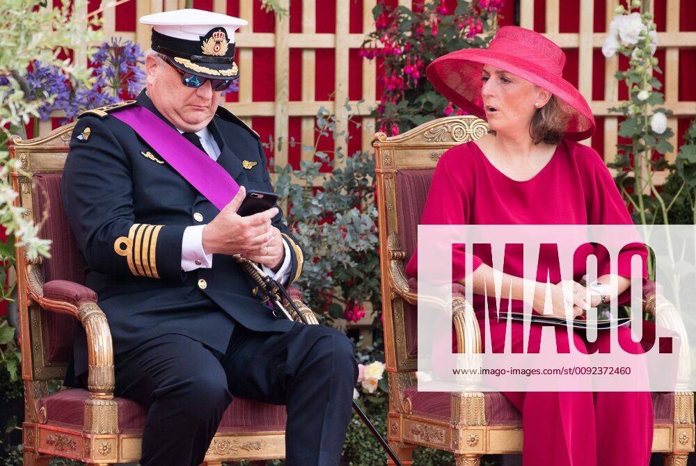 Prince Laurent using his smartphone and Princess Claire of Belgium pictured during the military parade on the Belgian National Day, in Brussels, Sunday 21 July 2019. BENOITxDOPPAGNE 05631691