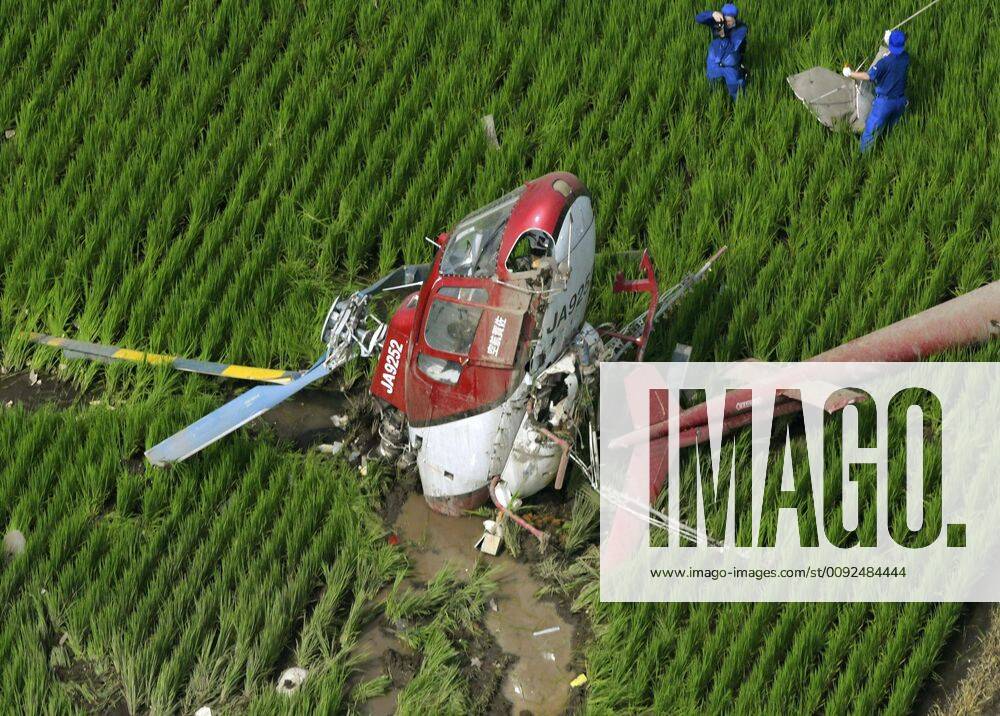 Crop-dusting helicopter crash in Japan Photo taken July 29, 2019, from a Kyodo News helicopter shows a crop-dusting helicopter that crashed into a paddy field in Chikusei, Ibaraki Prefecture, eastern Japan, after it apparently struck a power line. The 49-year-old pilot didn t sustain any life-threatening injuries.