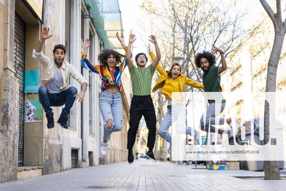 Happy group of friends having fun in the city jumping mid-air model released Symbolfoto AFVF03547
