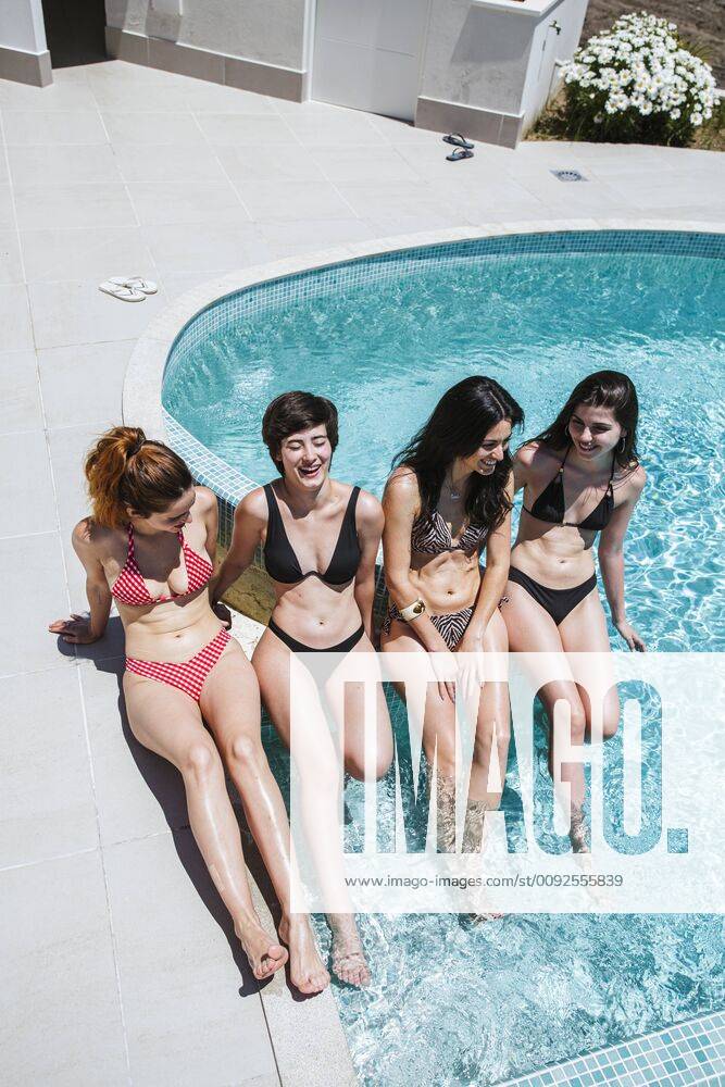 Young women enjoying the summer time at pool model released Symbolfoto property released LJF00212
