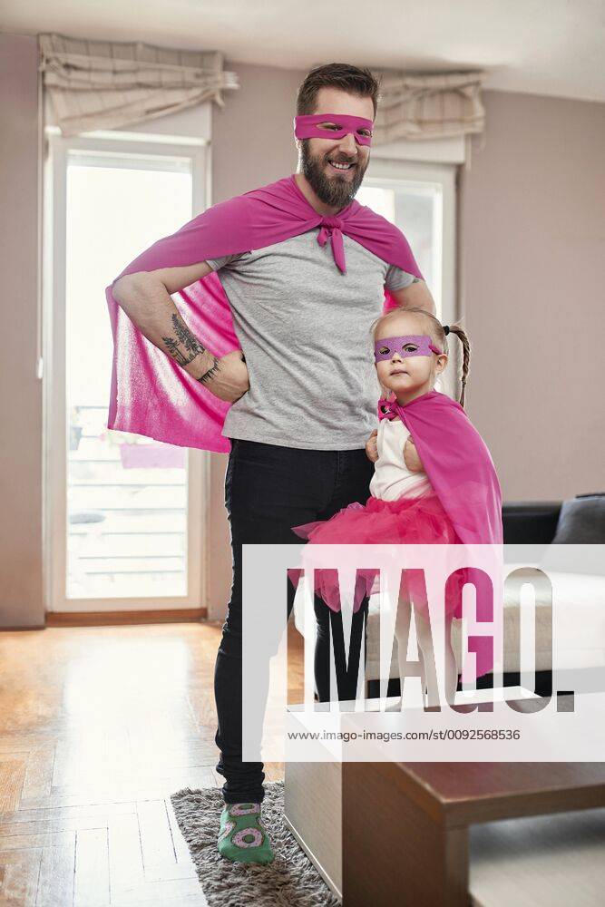 Father and daughter playing superhero and superwoman model released Symbolfoto property released ZEDF02484