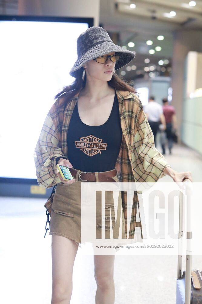 Chinese actress Zhong Chuxi arrives at the Shanghai Hongqiao International Airport after landing in Shanghai, China, 7 August 2019. Handbag & Hat & Baggage: Louis Vuitton Shoes: Nike Zhong Chuxi shows up at Shanghai airport after landing bjl13692012