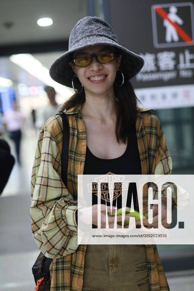 Chinese actress Zhong Chuxi arrives at the Shanghai Hongqiao International Airport after landing in Shanghai, China, 7 August 2019. Handbag & Hat & Baggage: Louis Vuitton Shoes: Nike Zhong Chuxi shows up at Shanghai airport after landing bjl13690745