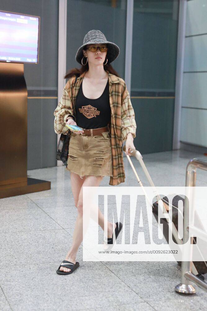 Chinese actress Zhong Chuxi arrives at the Shanghai Hongqiao International Airport after landing in Shanghai, China, 7 August 2019. Handbag & Hat & Baggage: Louis Vuitton Shoes: Nike Zhong Chuxi shows up at Shanghai airport after landing bjl13692021