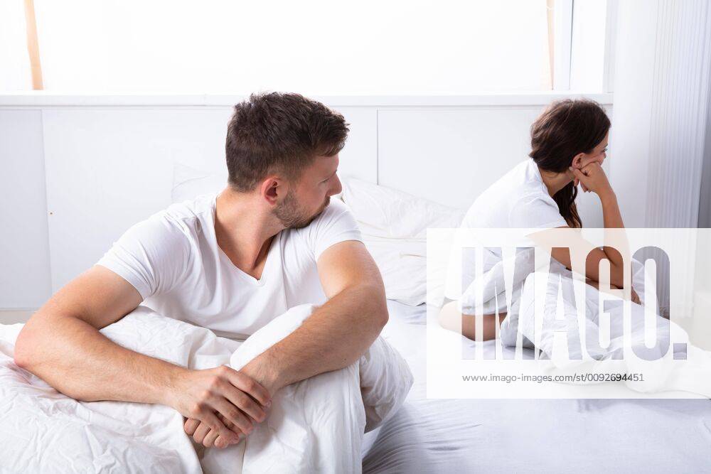 Unhappy Couple Sitting On Bed ,model released, Symbolfoto