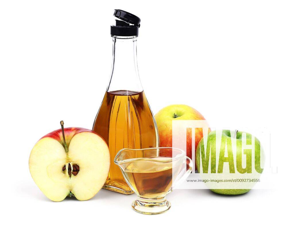 Bottle of Apple cider vinegar and apples.