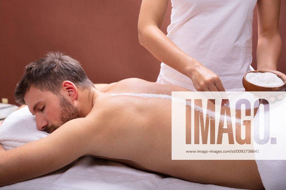 Therapist Applying Salt On Man s Back ,model released, Symbolfoto