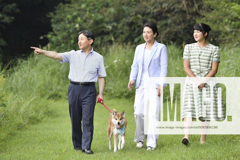 Japan imperial family on summer vacation (From L) Japanese Emperor Naruhito, Empress Masako and their daughter Princess Aiko take a stroll with their dog Yuri at Nasu Imperial Villa in Tochigi Prefecture, eastern Japan, on Aug. 19, 2019. (Pool photo)