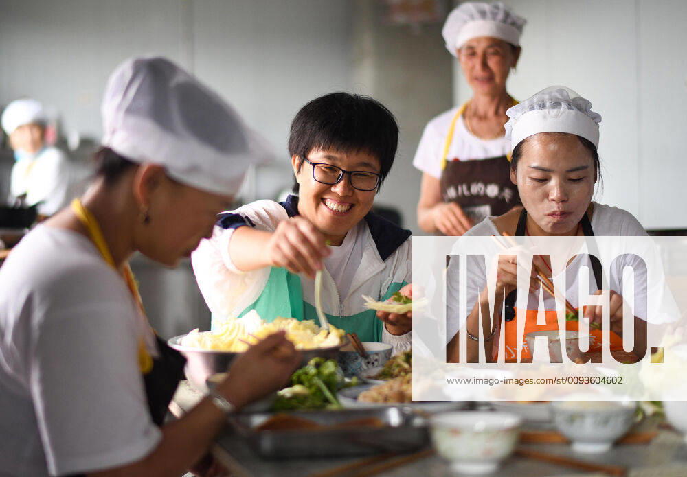(190923) -- BEIJING, Sept. 23, 2019 -- Li Chencan (C) and workers have lunch at a workshop in Xingbei Village of Wanfa Township in Bayan County, northeast China s Heilongjiang Province, Aug. 30, 2019. Li Chencan, a farmer born in the 1980s in Xingbei Village, opened an online shop with the help of her family members in 2014 to sell agricultural products produced in northeast China. To expand the online market, Li not only learned the methods of operating and maintaining online shops on her own, but also hired local farmers to better manage the shop and inked agreements with impoverished households to increase the product categories. Supported by the local government, Li s online shop has generated more than one million yuan (about 140,603 U.S. dollars) last year. In addition to selling over 200 categories of edible products online, s