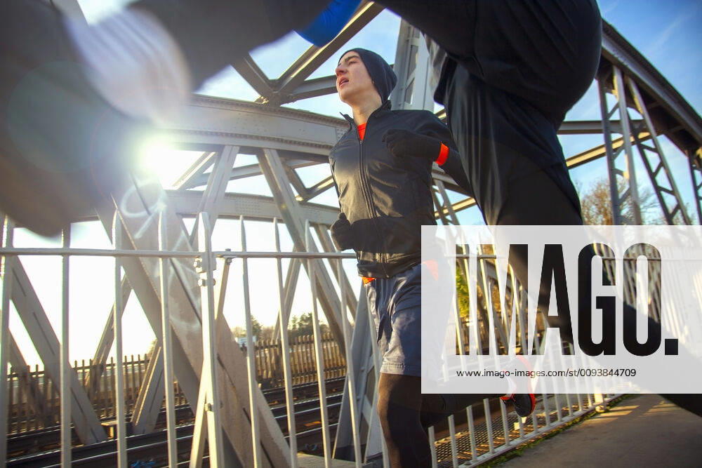 Two teenagers running over railway bridge model released Symbolfoto AJOF00001