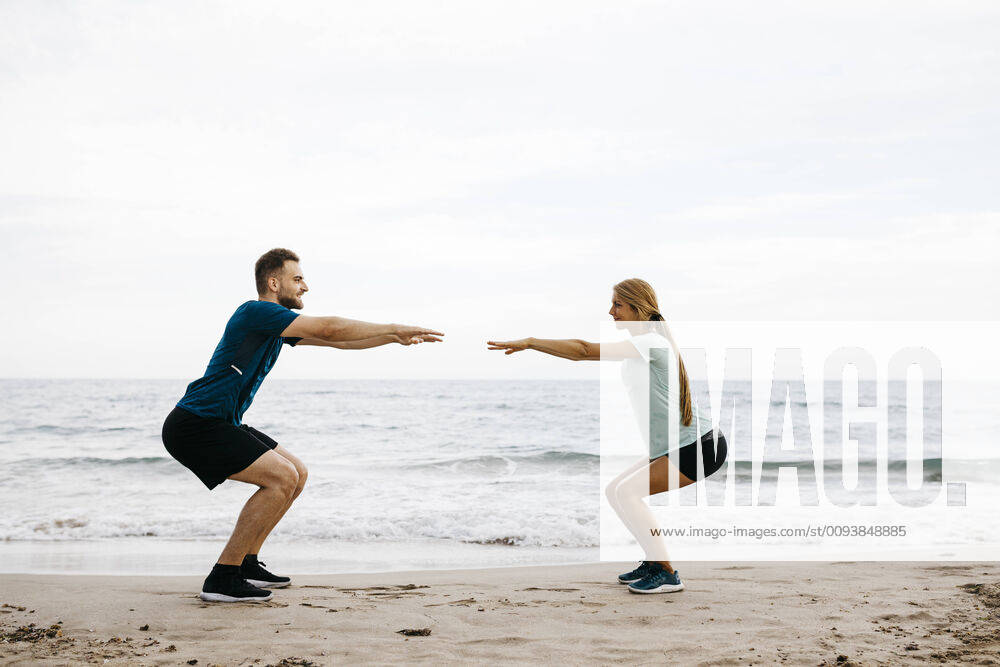 Young couple during training on the beach model released Symbolfoto JRFF03671
