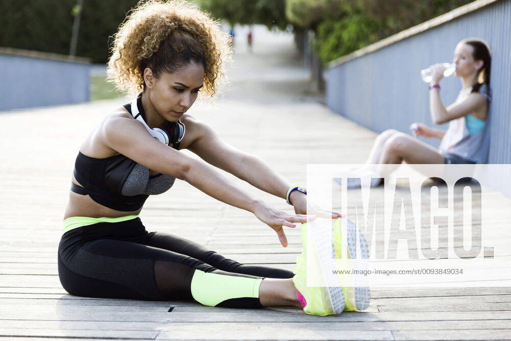 Sporty woman doing stretching exercise on a bridge model released Symbolfoto JSRF00498