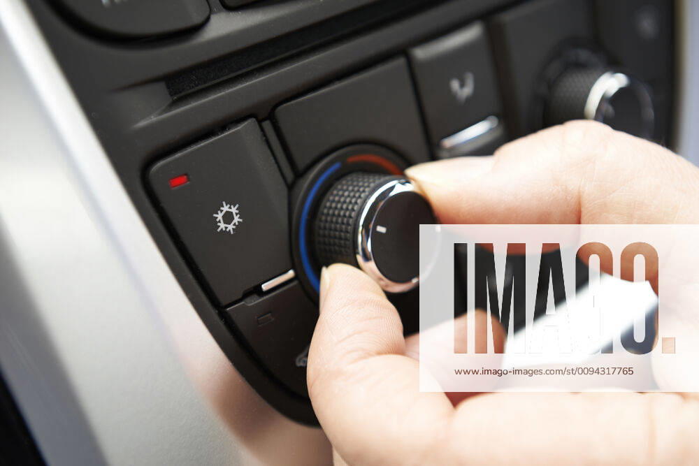 Close Up Of Hand Adjusting Car Air Conditioning Control On Dashboard ING_39524_01588