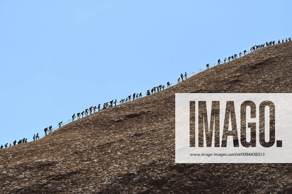 ULURU CLIMB CLOSURE COVERAGE, Tourists are seen climbing Uluru, also known as Ayers Rock at Uluru-Kata Tjuta National Park in the Northern Territory, Friday, October 25, 2019. Today is the last day people will be able to climb Uluru. ( NO ARCHIVING, , NO USE IN BOOKS WITHOUT CONSENT YULARA NT AUSTRALIA
