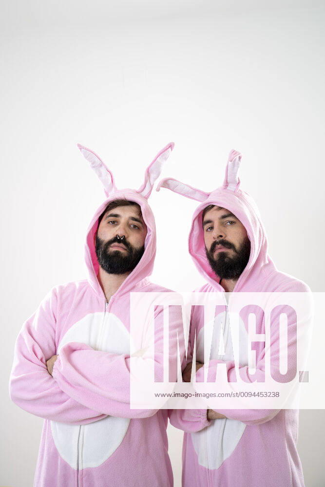 Two male friends with rabbit costumes in front of white background model released Symbolfoto AFVF04147