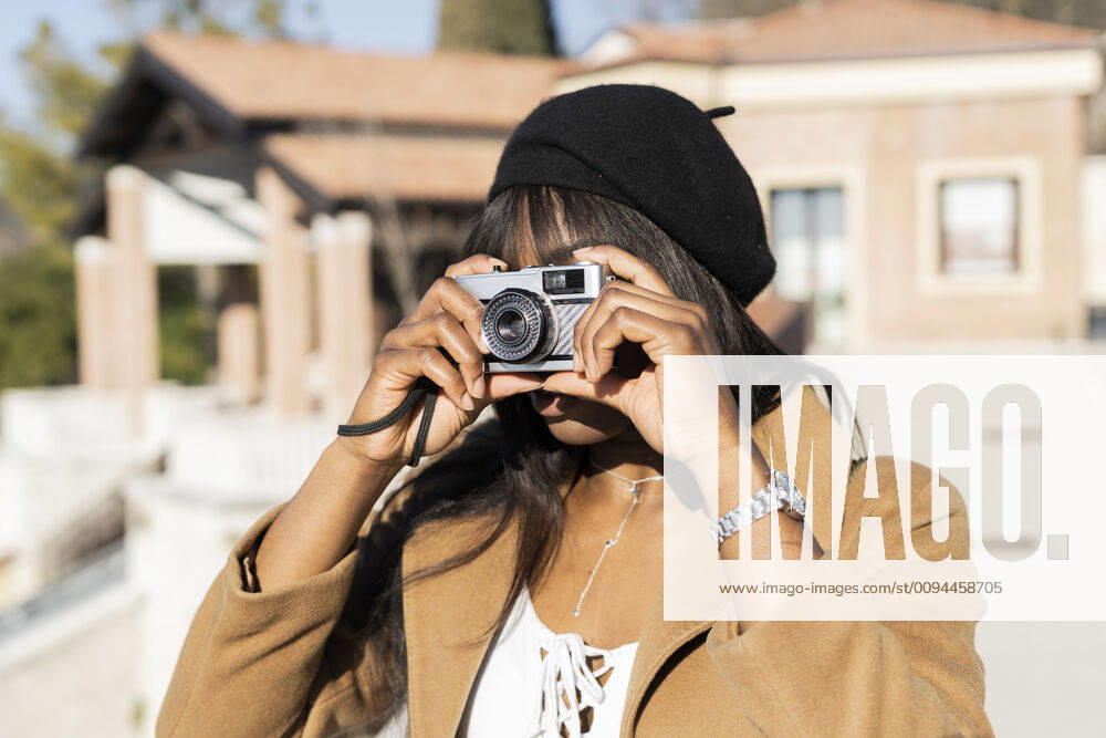 Female tourist taking a photo outdoors model released Symbolfoto GIOF07274