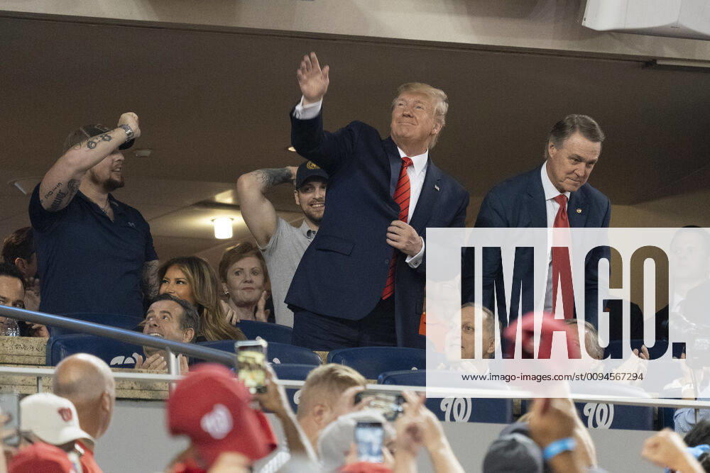 Washington DC- United States President Donald J. Trump acknowledges the crowd during a moment to salute the military during game five of the World Series at Nationals Park in Washington DC on October 27, 2019. The Washington Nationals and Houston Astros are tied at two games going into tonight s game. Pictured at right is United States Senator David Perdue (Republican of Georgia).