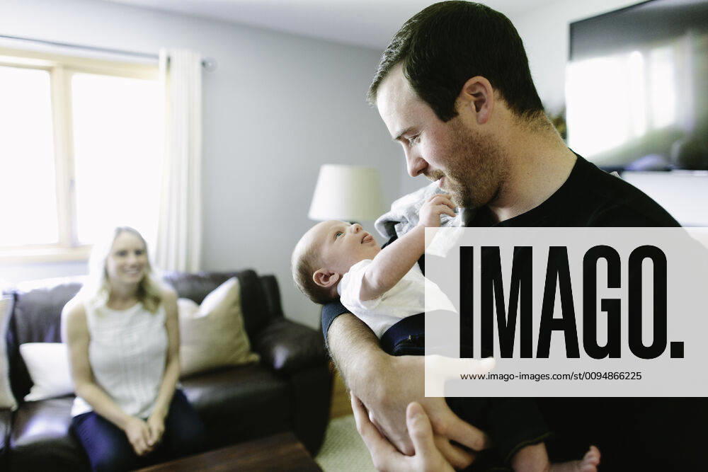 A new father holds his newborn baby son while the mom looks on United States, Minnesota, Minneapolis R_BSYP191018B-12883-01