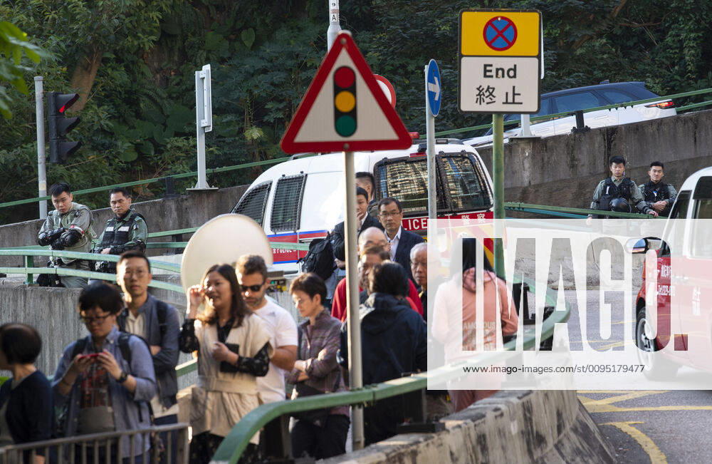 Hong Kong Police tactical unit watch over the area.Hong Kong Chief Executive, CARRIE LAM, votes in the local council elections. Lam meets the press at Raymond College in Midlevels Central to cast her vote in an election predicted to show Hong Kongers true views following 5 months of protests. Hong Kong China - ZUMAr144 20191124_zap_r144_006
