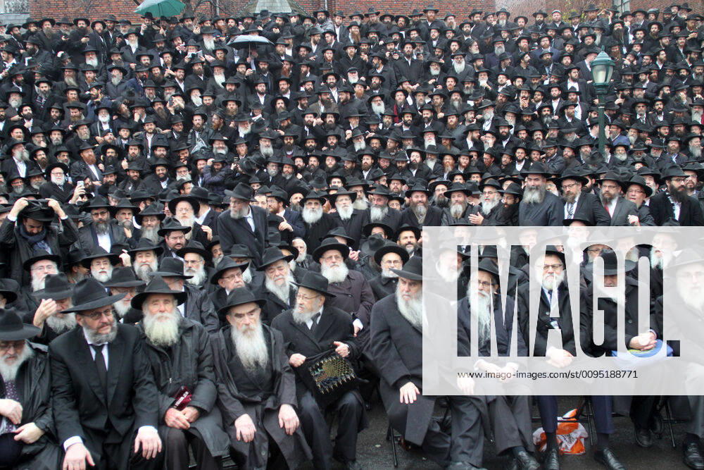 Thousands of Rabbis pose for their annual group photo in front of Chabad - Lubavitch world headquarters in Brooklyn New York. The rabbis come from around the for a week of lectures and seminars before heading back to their congregation. The rain stopped long enough for the photo to be taken then afterwords the rain started up again. New York USA - ZUMAct2_ 20191124_zaf_ct2_043