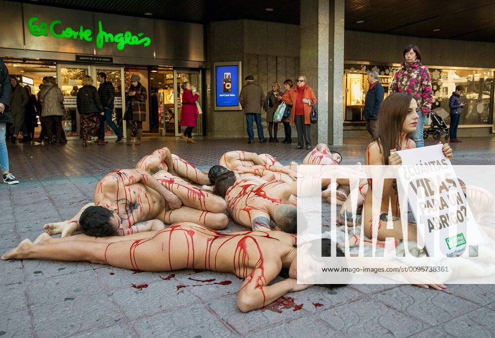 Activists of AnimaNaturalis organization in defense of the animal rights covered in fake blood take part in a protest action against fur industry in? Zaragoza, Spain, 15 December 2019. Protest against fur industry in Zaragoza !ACHTUNG: NUR REDAKTIONELLE NUTZUNG!