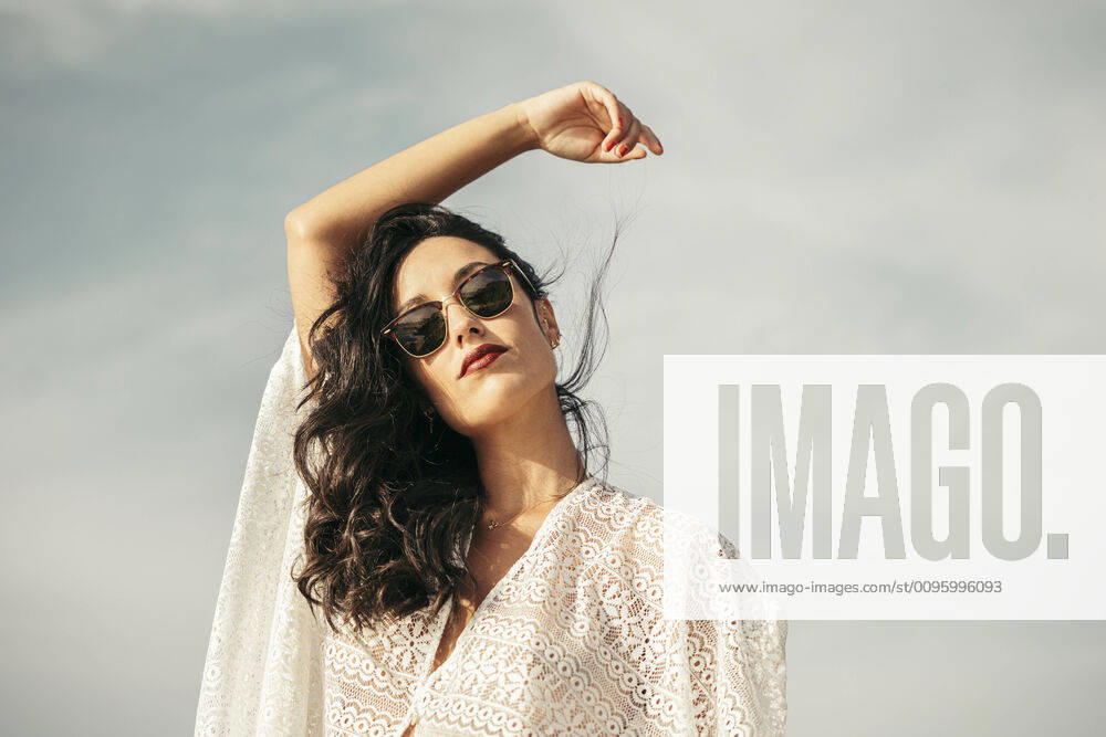 Portrait of young woman with raised arm and sunglasses model released Symbolfoto MTBF00231