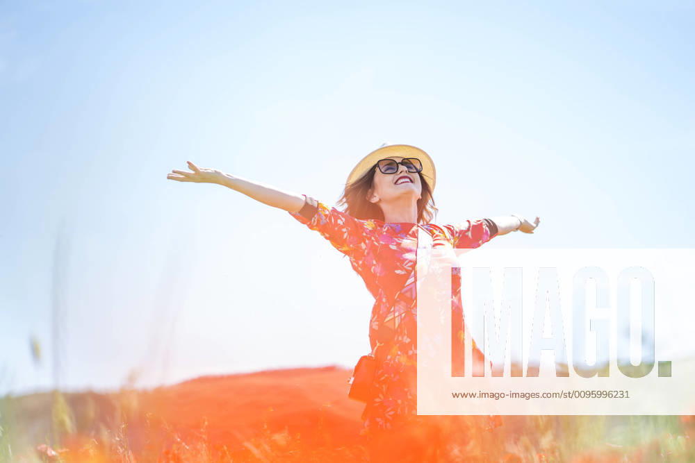 Happy woman on a meadow looking up to the sky model released Symbolfoto OCMF00943