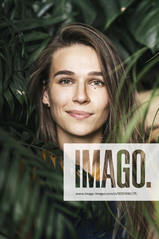 Portrait of a young woman amidst green plants model released Symbolfoto property released VPIF01892