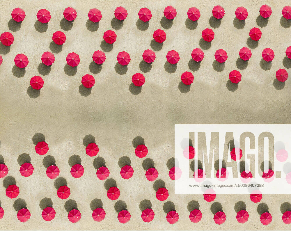 Aerial view of arrangement of red beach umbrellas on sandy beach KNTF04088