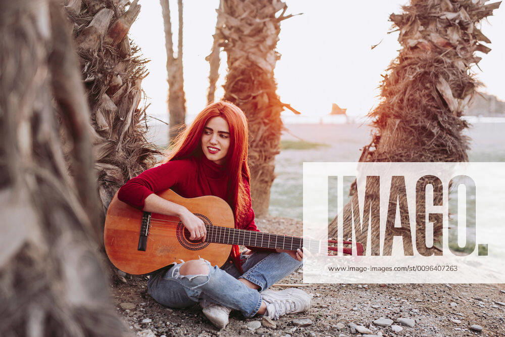 Portrait of young woman playing guitar on the beach, Almunecar, Spain model released Symbolfoto LJF01213