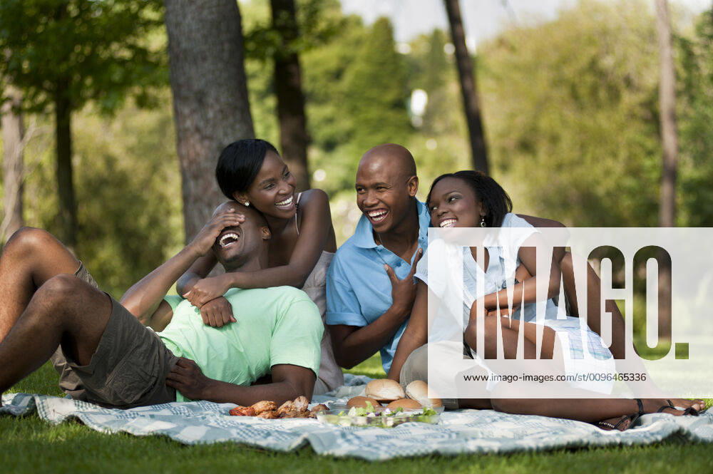 A group of Young African friends picnic together in a park