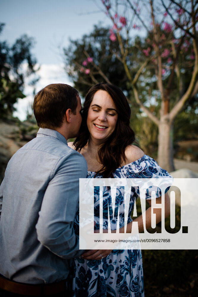 Husband Hugging Pregnant Wife as she Smiles San Diego, CA, United States CR_JIDE191205B-242325-01