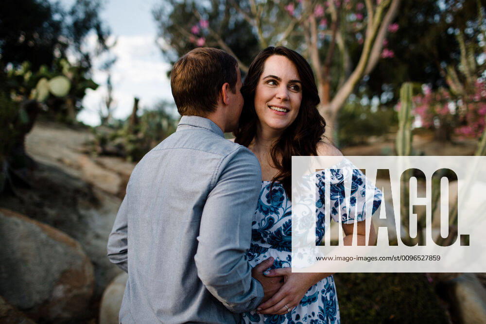 Husband Hugging Pregnant Wife as She Smiles San Diego, CA, United States CR_JIDE191205B-242326-01