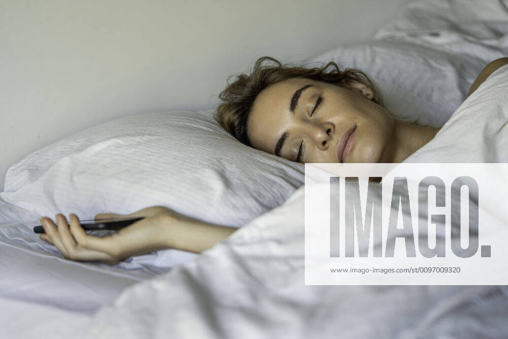 Young woman sleeping with smartphone