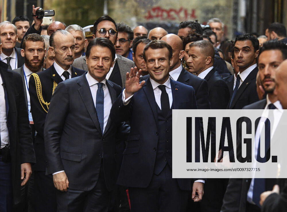 French President Emmanuel Macron with Italian Prime Minister Giuseppe Conte walk the streets of central Naples before the Franco-Italian summit begins, in Naples, southern Italy, on February 27, 2020