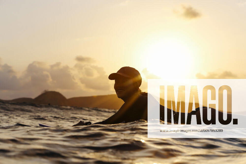 Female surfer lying on surfboard in the evening Lombok, Nusa Tenggara Bar., Indonesia ,model released, Symbolfoto CR_KOTRIN200120S-290422-01