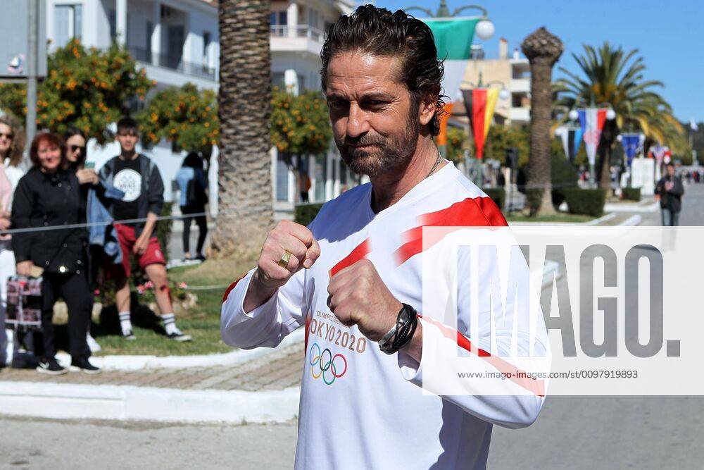 Actor JERARD BUTLER in the Olympic Torch relay on March 13, carrying the Olympic Flame from the Byzantine town of Mystras to Sparta for the 2020 Olympic Games in Tokyo. Sparta Greece - ZUMAv62_ 20200313_zaf_v62_058
