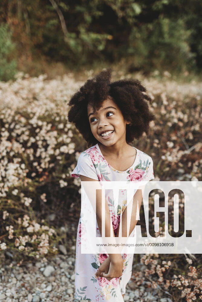Portrait of young school-aged girl smiling in field of flowers San Diego, CA, United States ,model released, Symbolfoto CR_KESM200220B-196704-01