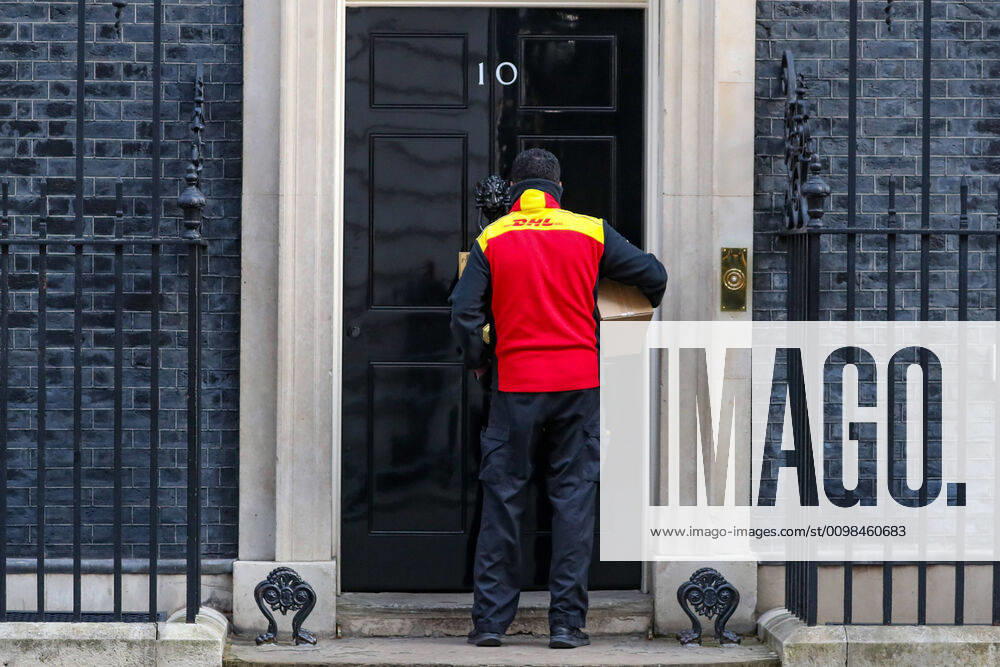 A DHL delivery guy wearing face protective mask as well as surgical gloves is seen arriving in Downing Street, London on Tuesday, March 24, 2020, the day after Prime Minister Boris Johnson put the UK in lockdown to help curb the spread of the coronavirus. (Photo Vudi Xhymshiti) iMagoVX