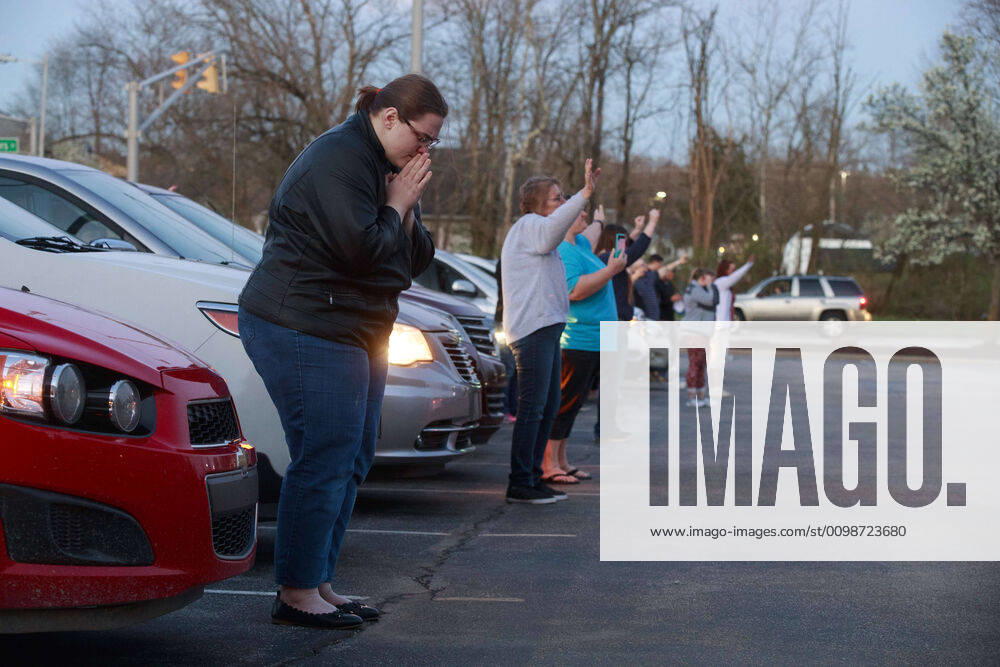 A group of community members from the Lighthouse Fellowship Church gather on a Sunday night outside the Bloomington Hospital to pray for doctors, nursing staff, and other workers, who are caring for patients, including some of the 22 people in Monroe County confirmed to have been sickened by COVID-19 Coronavirus..A similar prayer took place yesterday in the state of Georgia. Bloomington United States - ZUMAs197 20200329_zaa_s197_163