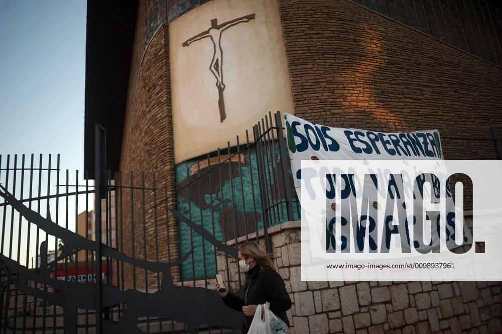 A woman wearing a face mask as a preventive measure, walks outside a church during the fight against the Covid-19 virus outbreak..Spain is the first country in Europe with more than 110.000 people infected and almost 11.000 deaths around the country, according to National Health Service sources. Andalusia is the city with more people infected by the virus. Malaga Spain - ZUMAs197 20200403_zaa_s197_265