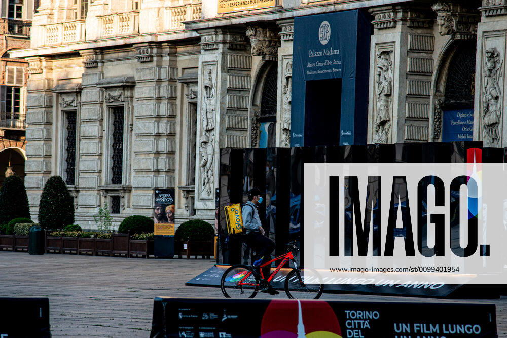 Italy: Turin lockdown 14th April 2020 An delivery man wering an safety mask in Piazza Castello in a deserted Turin on April 14, 2020 in Italy, during the country s lockdown aimed at curbing the spread of the COVID-19 infection, caused by the novel coronavirus. Turin Piedmont Turin Italy
