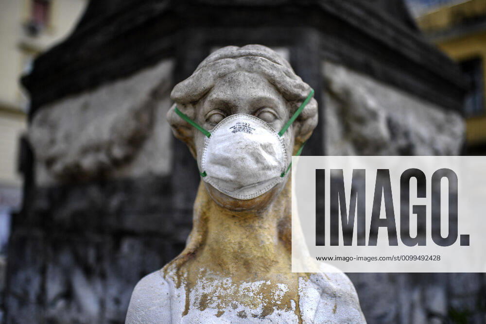 A protective mask is placed on a statue of a sphinx in Piazza Mercato (Marketplace Square), one of the most symbolic and historical places in Naples. Government Decree declaring all of Italy a protected area to combat Covid-19 - Coronavirus infection.