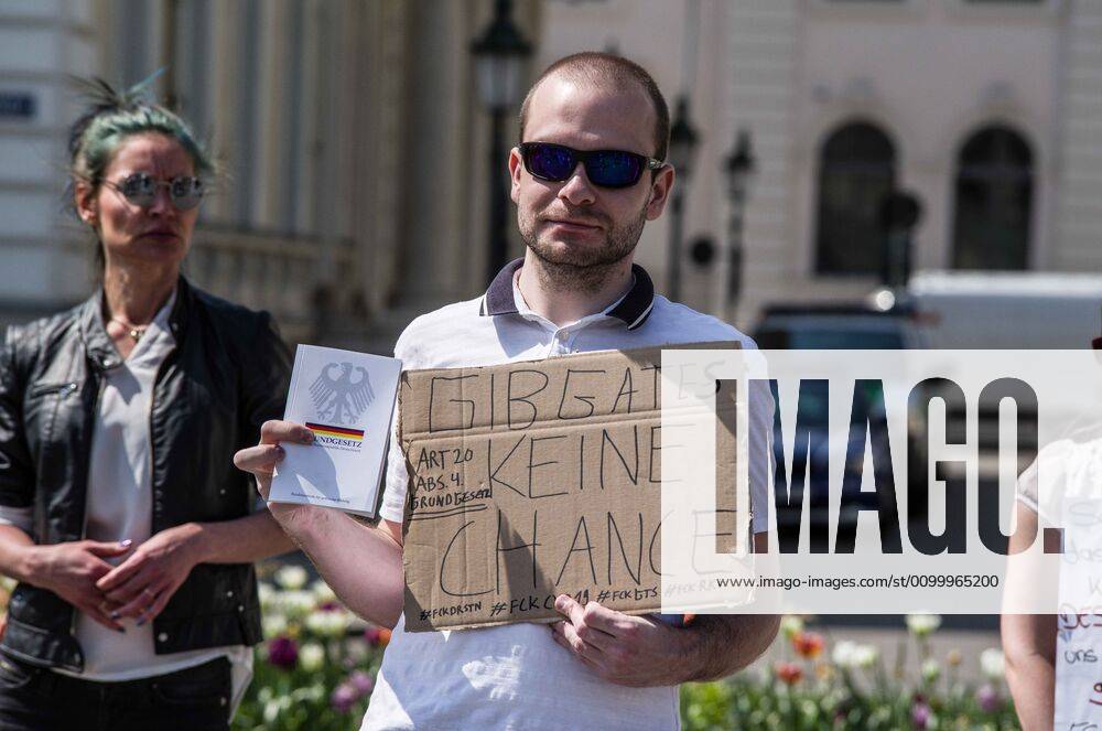 Don t give Bill Gates a chance worn at a QAnon-like demo in Munich, Germany. Organized in Telegram chats by conspiratorial â€oeQuerfront†(cross-front) groups, the city of Munich, Germany saw numerous QAnon-like, â€oeCorona Parties†as under mottos such as â€oeDemonstration fuer die Erhaltung der Grundrechte†(Demonstration for the Upholding of Basic Rights) and â€oeFuer unsere Freiheit, unsere Grundrechte und unsere Selbstbestimmung†(Demonstration for our Freedom, Basic Rights, and Self-Determination). Numerous right-extremists, Verfassungsschutz-monitored figures, QAnon fans, and AfD politicians were in attendance. The groups are of the belief that the anti-Coronavirus measures are power-grabs. Querfront groups are often a mix of political outliers, - ZUMAb160 20200425_zbp_b160_004